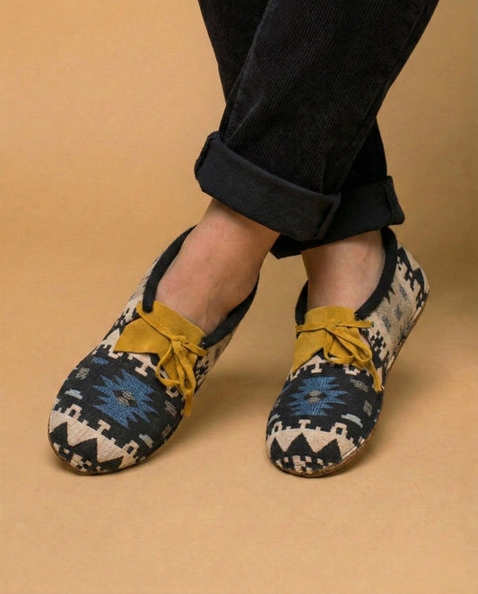Moccasins with a woven cream and charcoal jacquard diamond pattern and a mustard suede collar