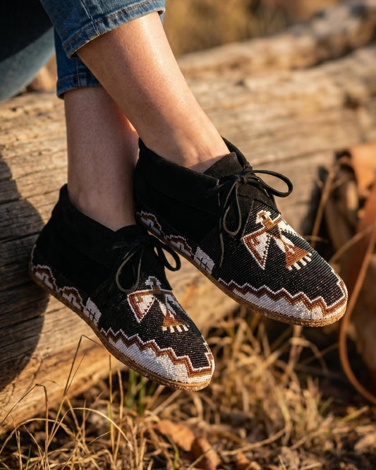 Hand-beaded black suede moccasins with a rainbow chevron flame vamp and a diamond border