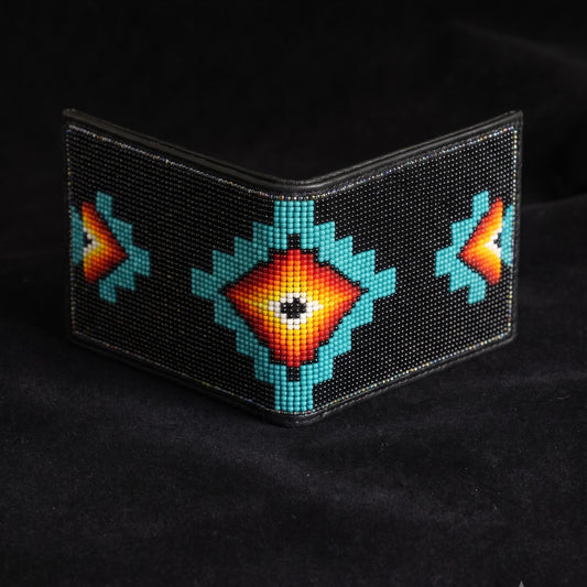 Black beaded leather bifold wallet with centered turquoise orange and yellow sunburst diamond design