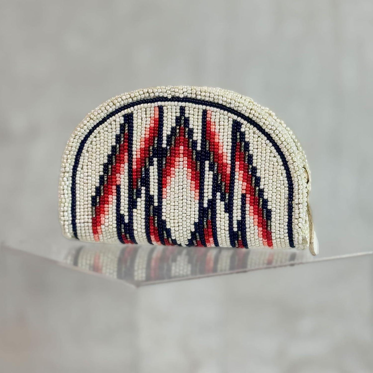 Hand-beaded pearl white coin purse with tall flame points in navy, red and coral pink