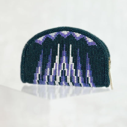 Hand-beaded coin purse in forest green with purple and white scallop peaks and a jagged mountain range