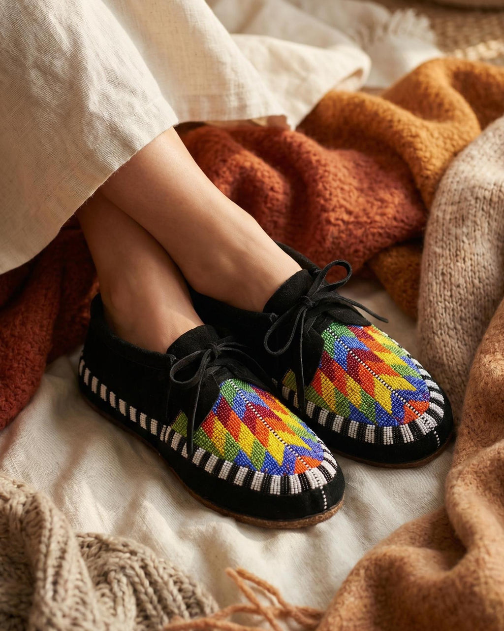 Geometric Beaded Black Suede Moccasins, Native American Inspired Lace-Up Shoes for Women, Boho Artisan Footwear Suitable For Outdoor Wear.