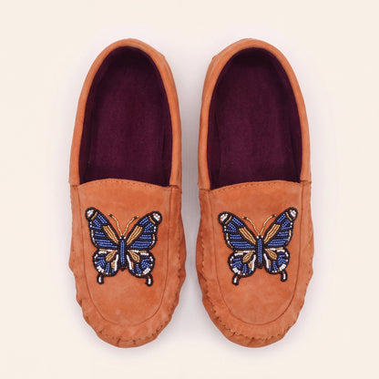 Top view of coral suede butterfly moccasins showing rich plum fabric lining
