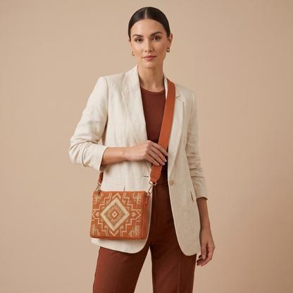 Rust geometric hand-beaded crossbody bag worn by model