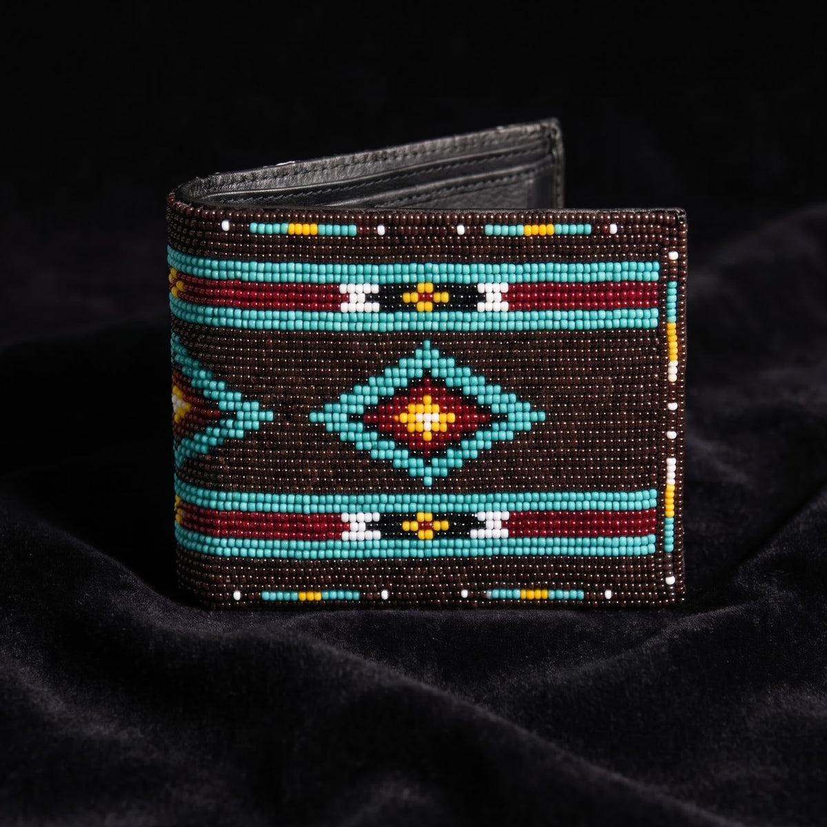 Dark brown hand-beaded leather bifold wallet with turquoise border lines and a centered orange yellow diamond motif