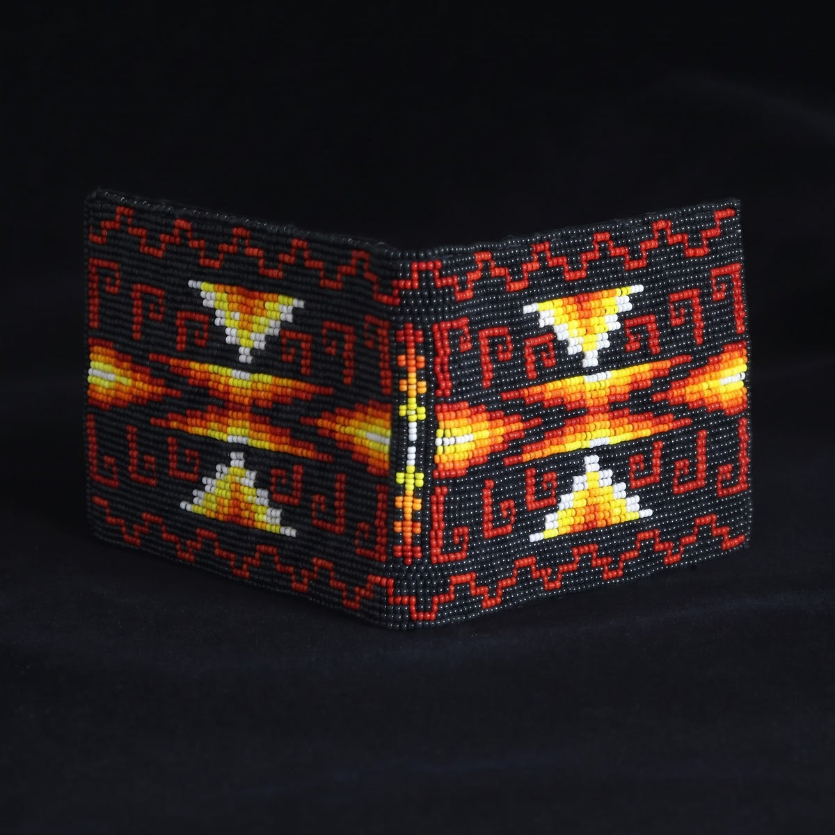 Black leather bifold wallet with red orange yellow and white hand-beaded stepped arrow design