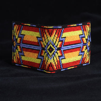 Orange and yellow leather bifold wallet with blue red and white hand-beaded sunburst diamond design