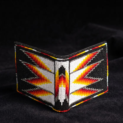 Black hand-beaded leather bifold wallet with bold white yellow orange and red symmetrical wing arrow geometric design