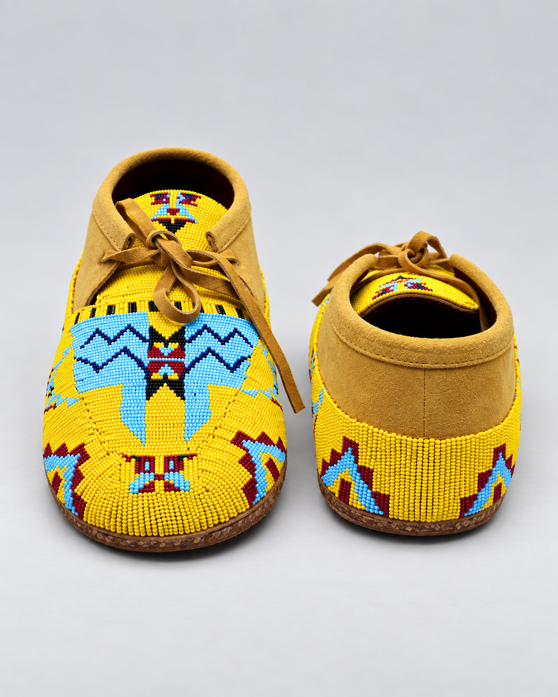 Front and back view of yellow hand-beaded men's moccasins